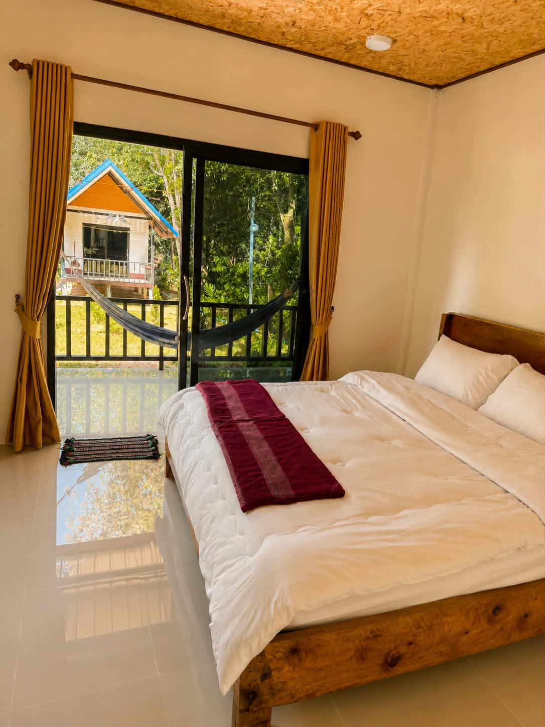 Room A3 made bed with garden view